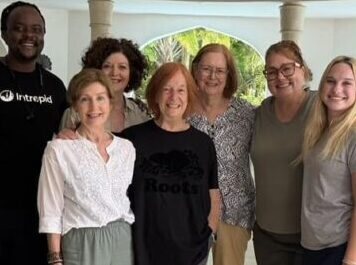 Kimberly Lorah and her daughter with four women they met during an African safari in Kenya, celebrating friendship, connection, and shared adventure.
